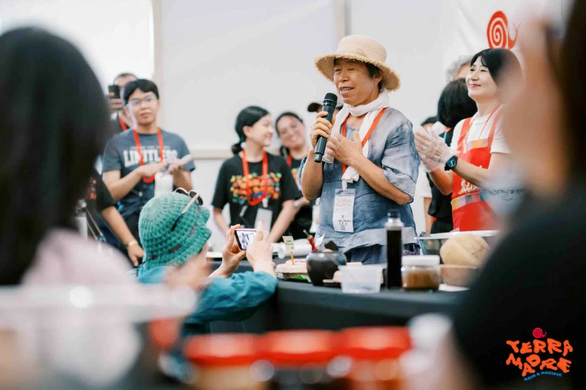 FIELD WISDOM A farmer shares community knowledge during a TMAP talk, grounding the discussion in lived experience and local food traditions.