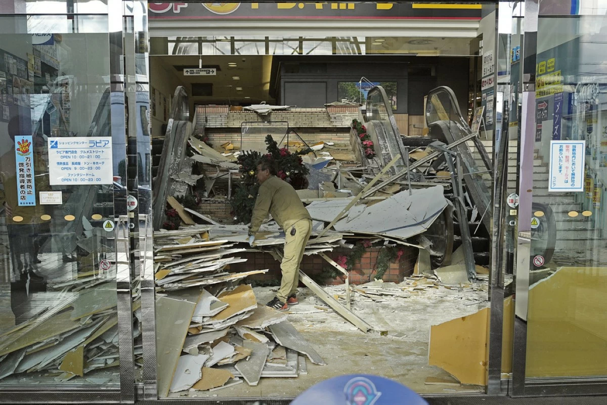 A man clears the debris from a powerful earthquake at a commercial facility in Hachinohe, Aomori prefecture, northern Japan Tuesday, Dec. 9, 2025. (Ren Onuma/Kyodo News via AP)