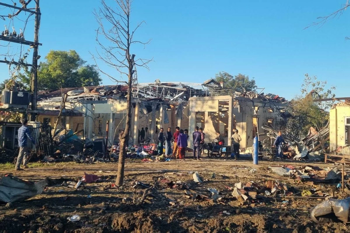 In this photo provided by Wai Hun Aung, people check damaged buildings at the hospital that was allegedly hit by a military air strike in Mrauk-U township in Rakhine state, Myanmar, Thursday, Dec.11, 2025. (Wai Hun Aung via AP)