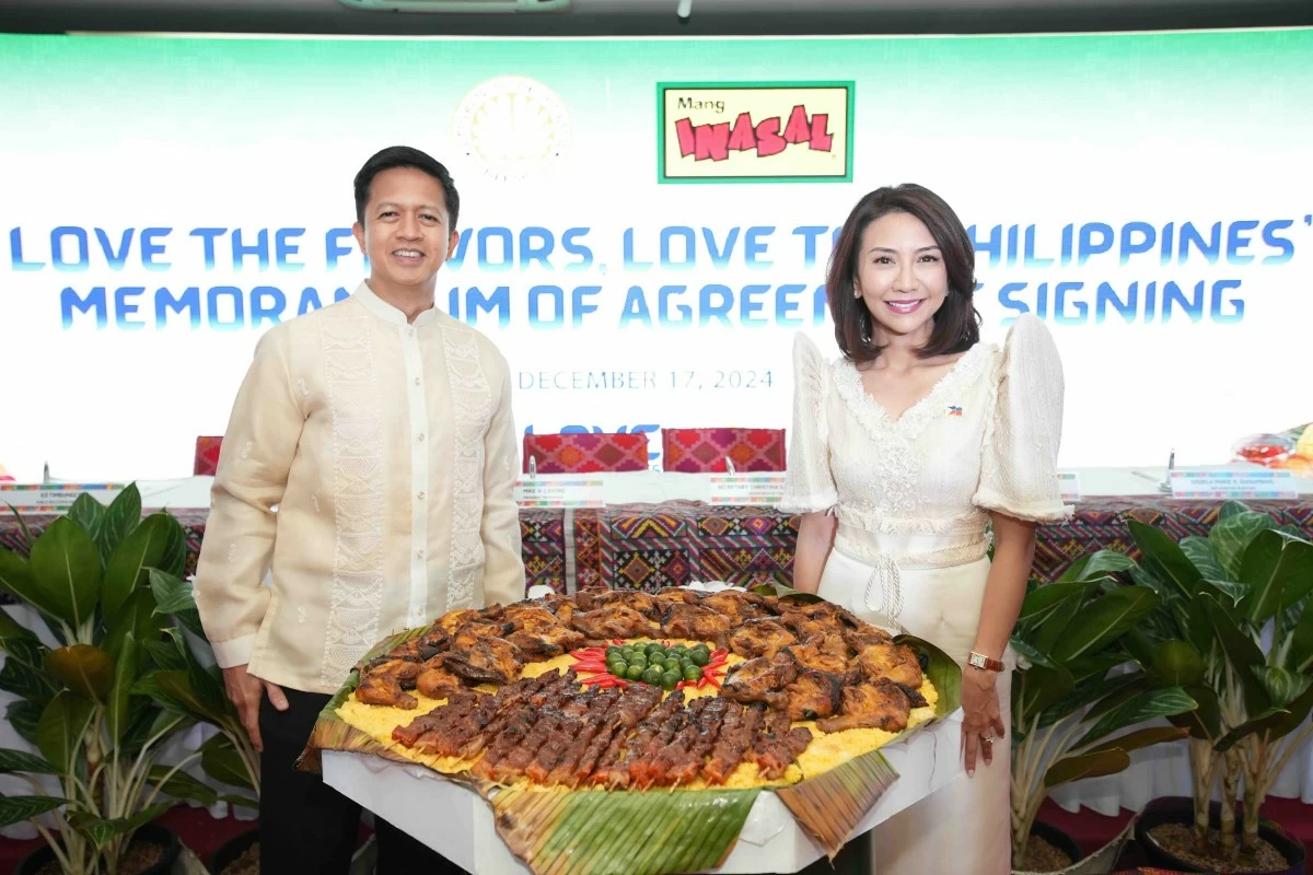 Mang Inasal President Mike Castro and DOT Secretary Christina Garcia-Frasco champion gastronomy tourism.