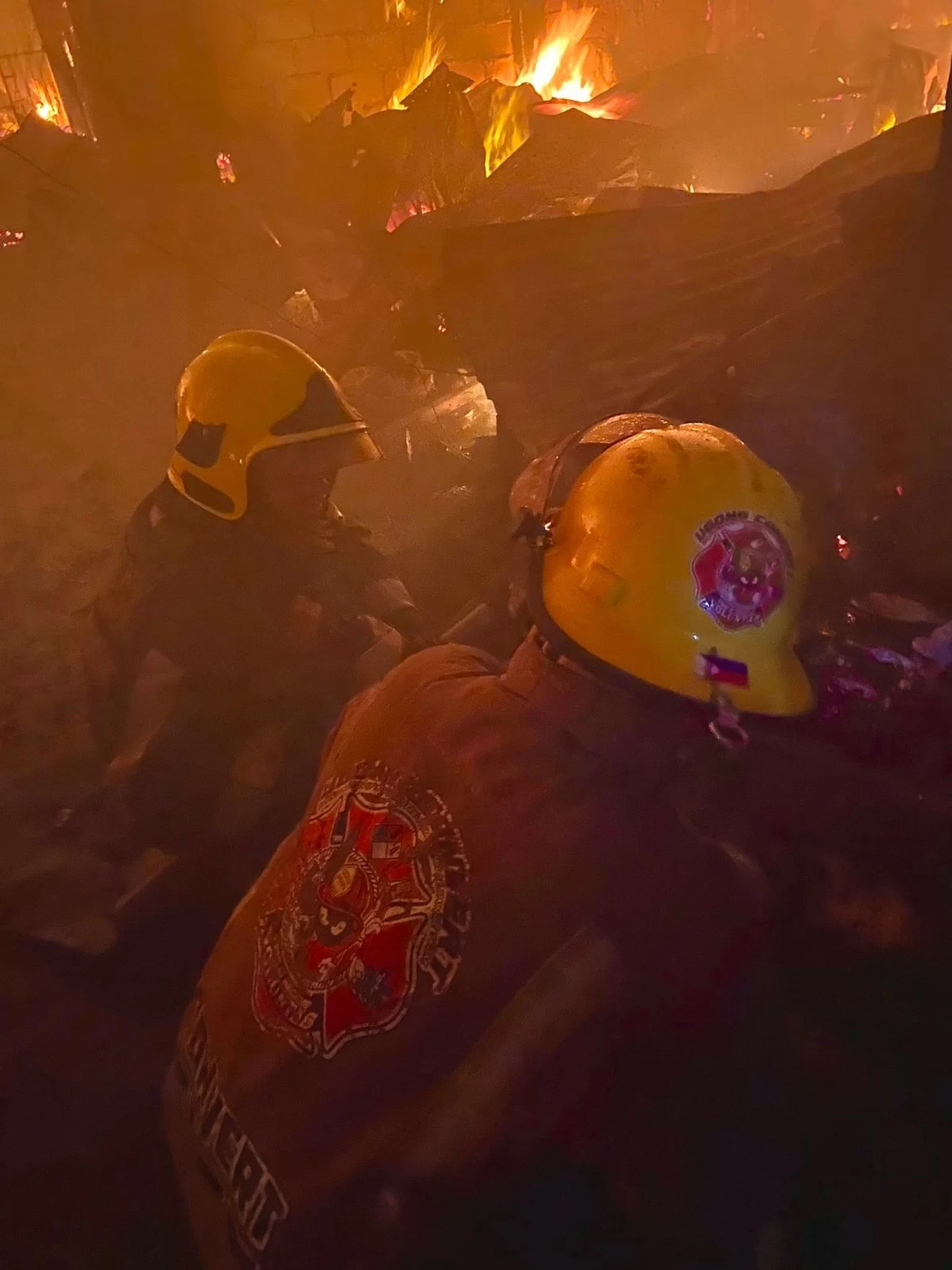 Firefighters and volunteers respond to a fifth-alarm blaze in a residential area in Mandaluyong City. (Photos from Ugong Convert Fire & Rescue Volunteers Brigade Inc.)