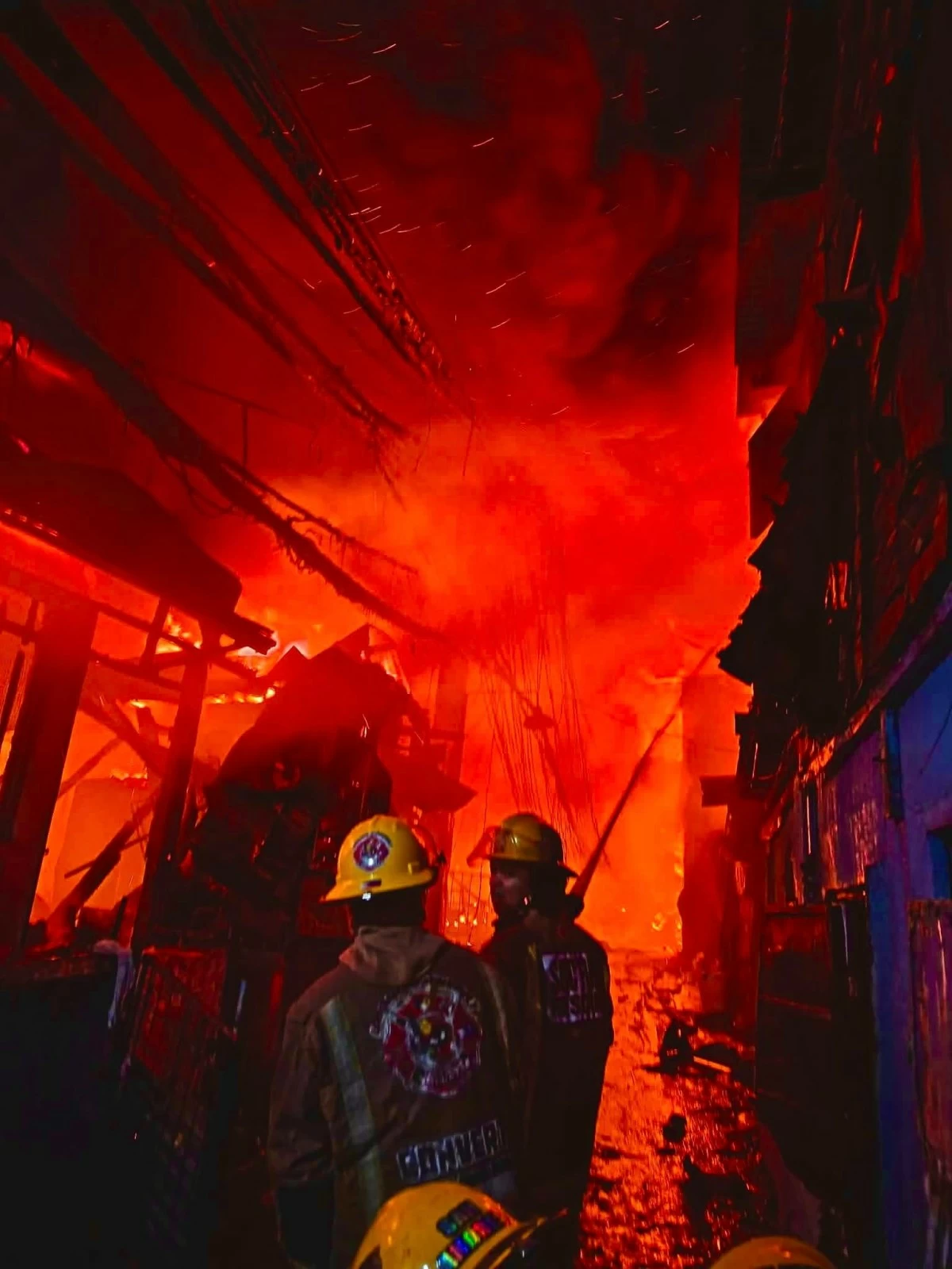 Firefighters and volunteers respond to a fifth-alarm blaze in a residential area in Mandaluyong City. (Photos from Ugong Convert Fire & Rescue Volunteers Brigade Inc.)