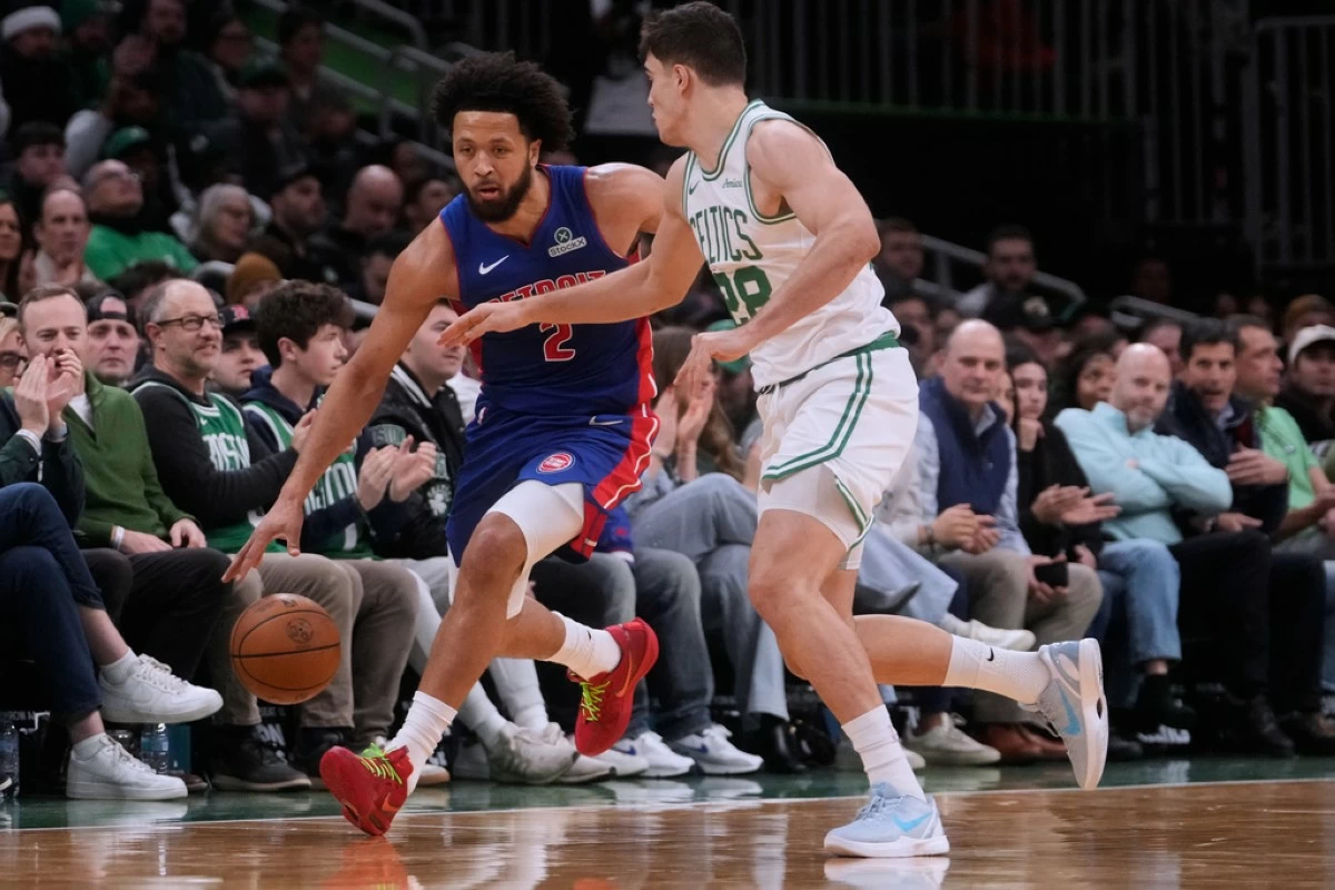 Detroit Pistons guard Cade Cunningham, left, drives to the basket against Boston Celtics guard Hugo Gonzalez, right, during the first half of an NBA basketball game, Monday, Dec. 15, 2025, in Boston. (AP Photo/Charles Krupa)