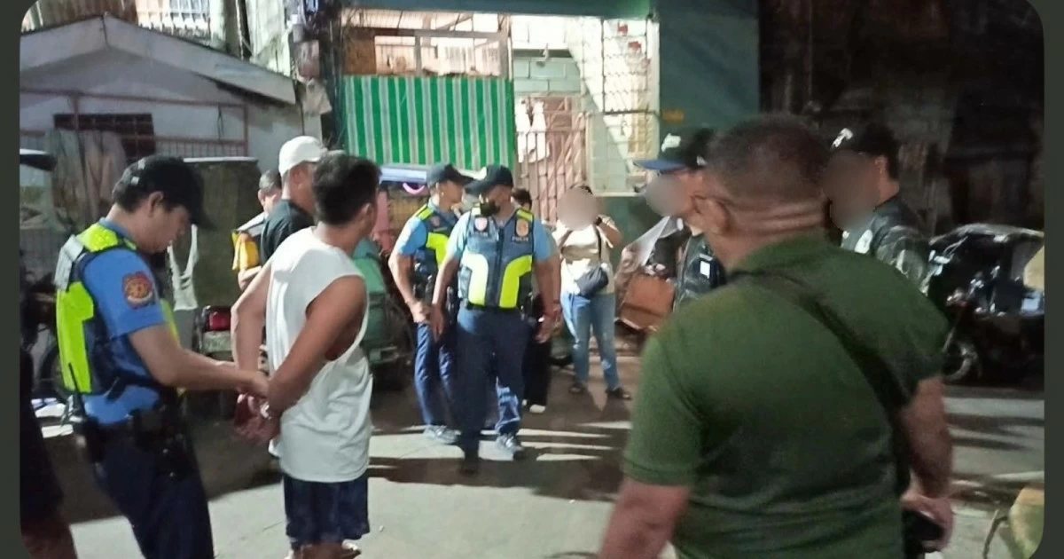 The suspect (wearing handcuffs) after his arrest at his home in Barangay Pembo, Taguig City. (Photo from SPD)