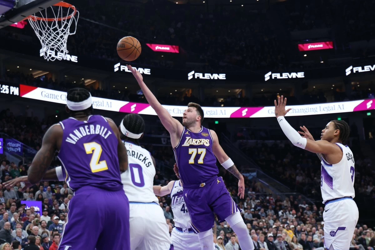 Los Angeles Lakers guard Luka Doncic (77) lays up the ball against the Utah Jazz during the first quarter of an NBA basketball game Thursday, Dec. 18, 2025, in Salt Lake City. (AP Photo/Rob Gray)