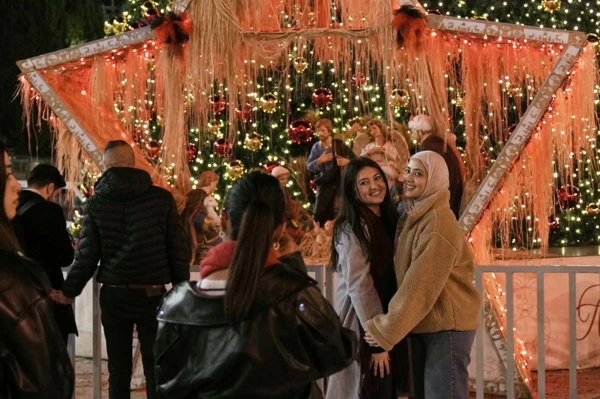 PEOPLE pose for a picture in Manger Square in the West Bank city of Bethlehem, Tuesday, Dec. 16, 2025. (AP)
