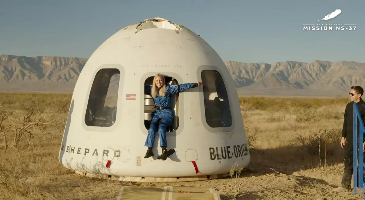 This image provided by Blue Origin, Michaela Benthaus poses after the Blue Origin's capsule landed on Saturday, Dec. 20, 2025 in West Texas.  (Blue Origin via AP)
