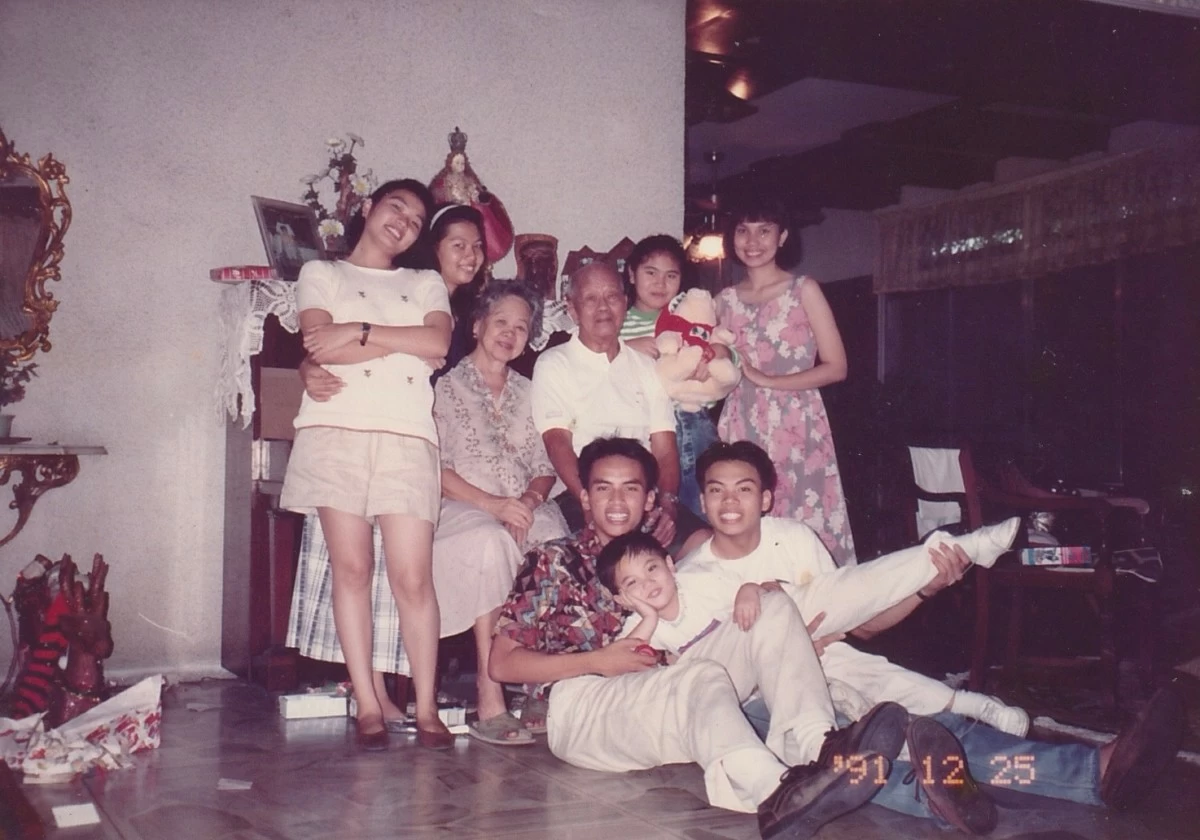 MALABON MORNINGS The author, reclining with one leg raised, is pictured with cousins and his paternal grandparents at his family home in Malabon after Christmas gift-opening, with wrappers still scattered around.