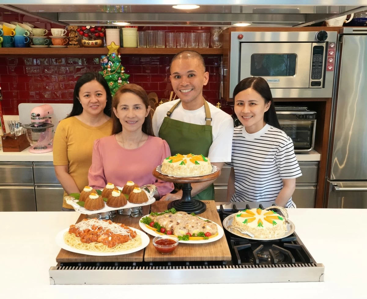 FAMILY CLASSIC Elder sister Dianne, Nanay Rose, Chef RV Manabat, and eldest sister Rosette with their holiday recipe spread, centered on the family’s traditional Christmas embotido.