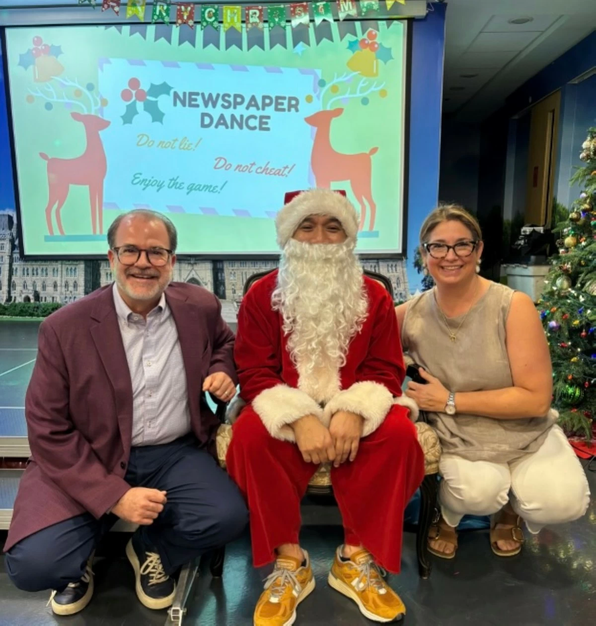 Ambassador Hartman and spouse Mme. Bethany Goldstein join Santa Claus in celebrating the season