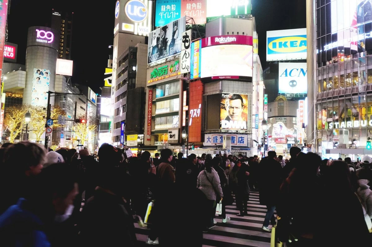 PEOPLE SCRAMBLE at the iconic Shibuya Crossing in Tokyo, where up to 3,000 individuals cross every turn of the green light.