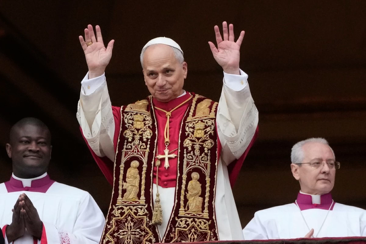 Pope Leo XIV waves after delivering the Urbi et Orbi (Latin for 'to the city and to the world' ) Christmas' day blessing from the main balcony of St. Peter's Basilica at the Vatican, Thursday, Dec. 25, 2025. (AP Photo/Gregorio Borgia)