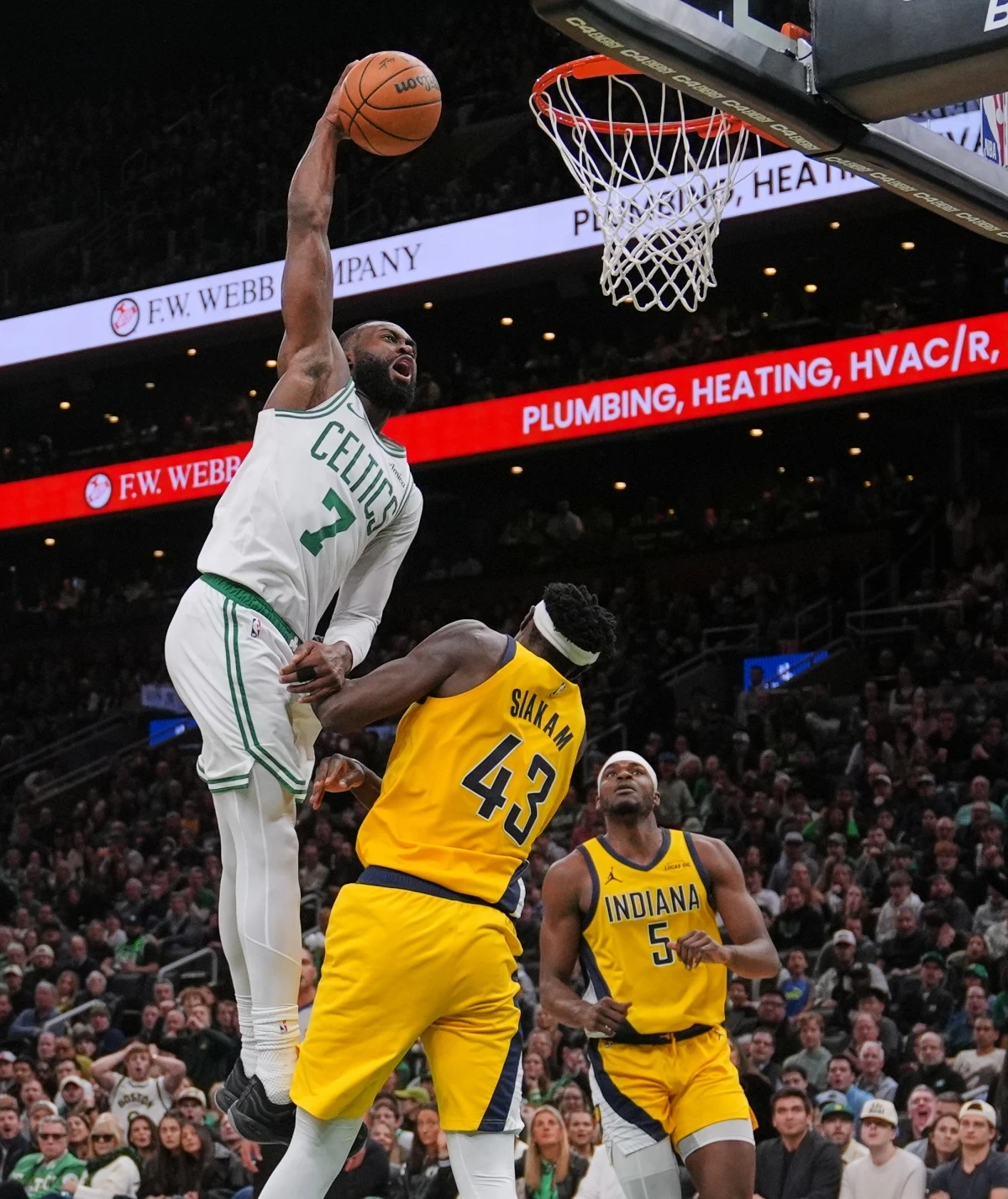 Boston Celtics guard Jaylen Brown (7) lines up a dunk over Indiana Pacers forward Pascal Siakam (43) during the second half of an NBA basketball game, Monday, Dec. 22, 2025, in Boston. (AP Photo/Charles Krupa)