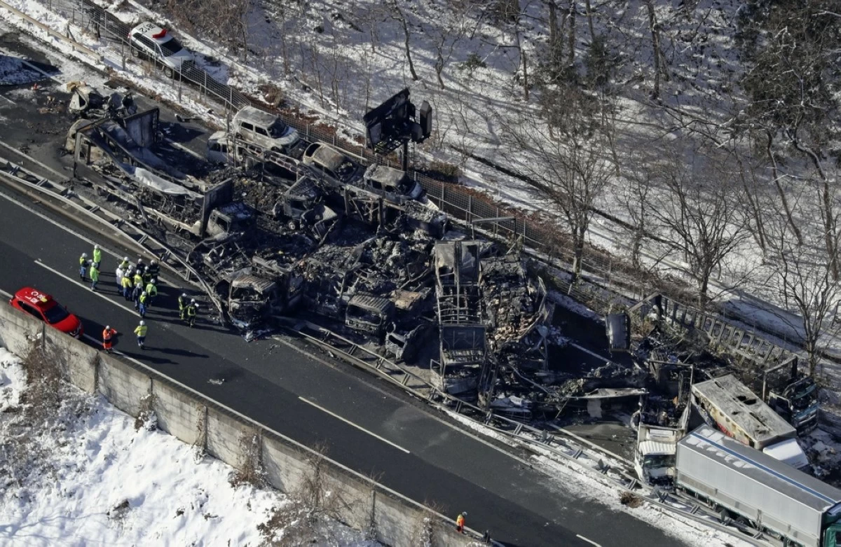 Burnt vehicles are seen after a massive crash on an expressway, in Minakami, northwest of Tokyo, Saturday, Dec. 27, 2025. (Kyodo News via AP)