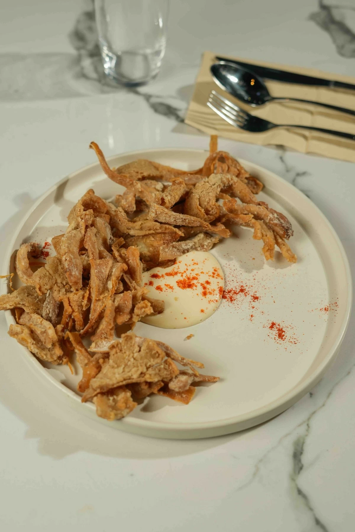 CRUNCH TIME Mushroom chicharon made with oyster mushrooms, tossed in sisig dressing and finished with lime juice.