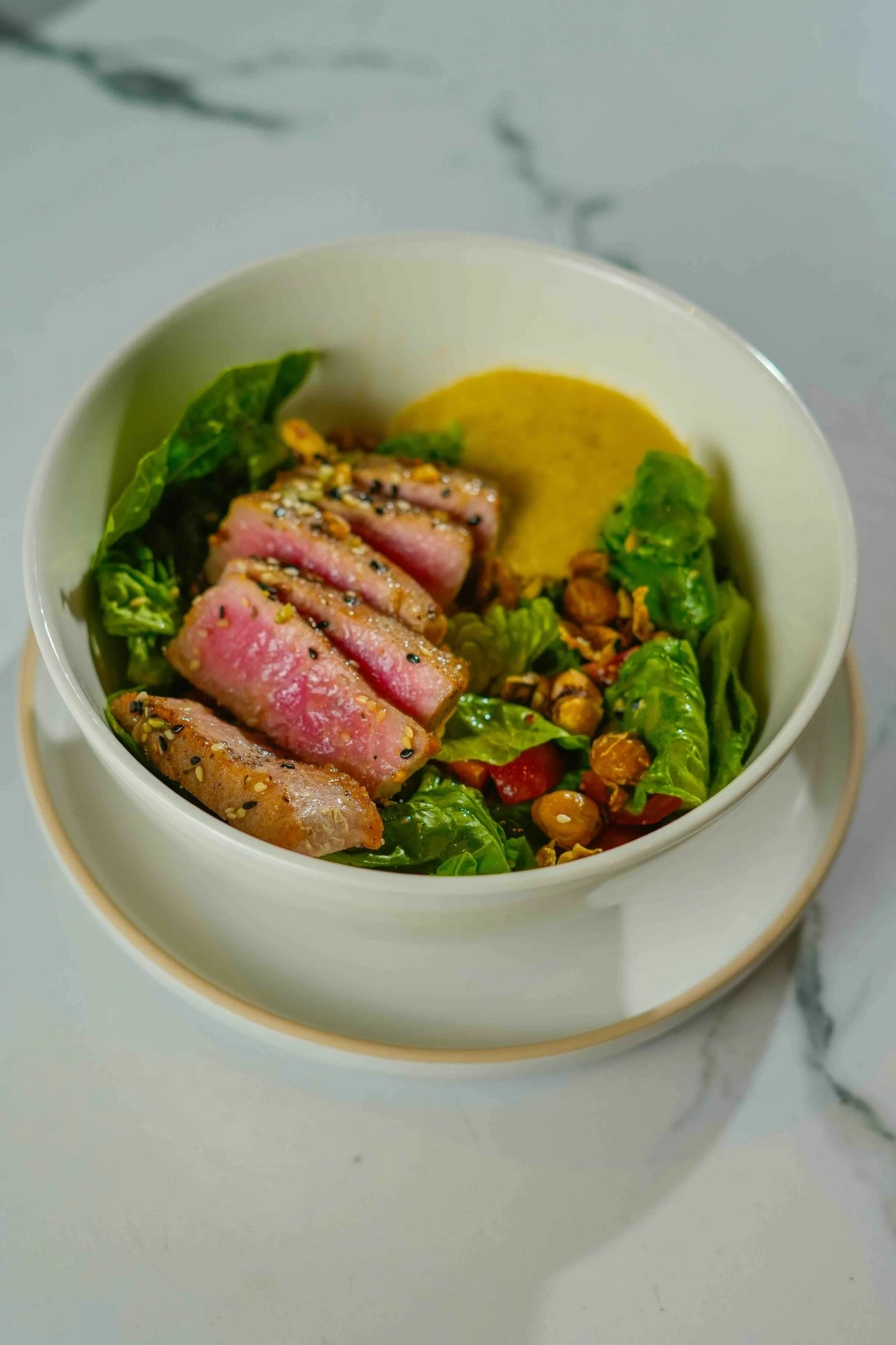 CLEAN EATS Seared tuna salad with mixed greens, sesame-seared tuna, house vinaigrette, crispy chickpeas and hummus.