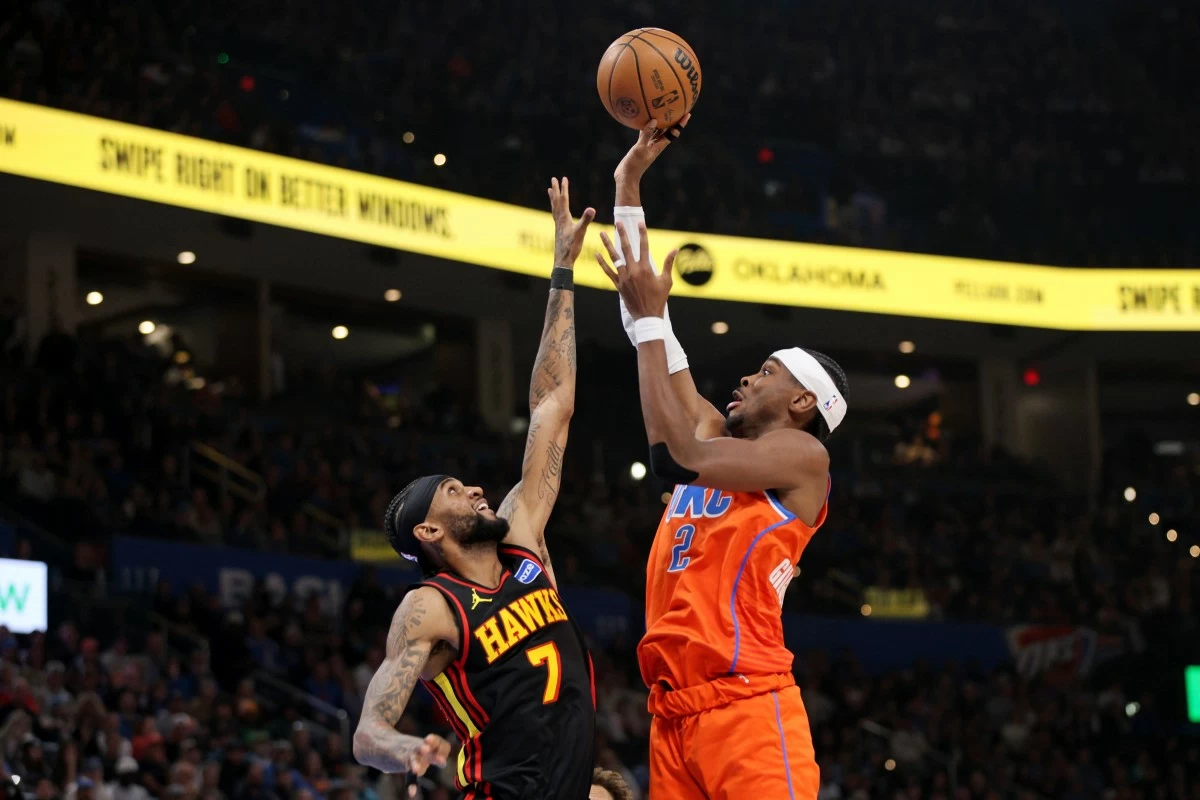 Oklahoma City Thunder guard Shai Gilgeous-Alexander (2) shoots over Atlanta Hawks guard Nickeil Alexander-Walker (7) during the second half of an NBA basketball game Monday, Dec. 29, in Oklahoma City. (AP Photo/Nate Billings)