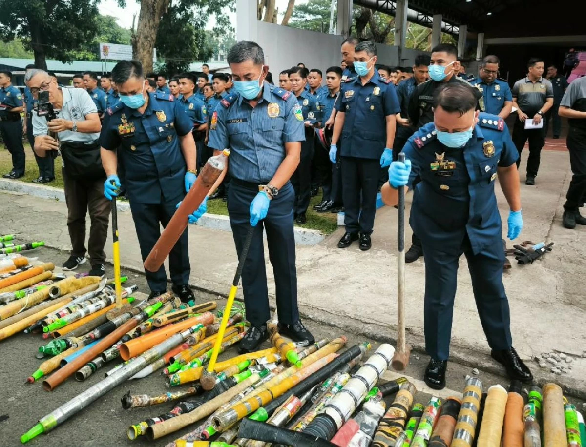 

POLICE Brig. Gen. Paul Kenneth Lucas (second from right), Police Regional Office 4-A director, and Police Col. Romulo Albacea  (right), Quezon provincial police director, destroy illegal firecrackers on Tuesday, Dec. 30, in Camp Vicente Lim, Laguna. (Danny Estacio)

