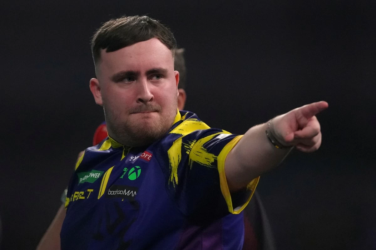 England's Luke Littler reacts during his semifinal match against England's Ryan Searle at the World Darts Championships, at Alexandra Palace in London, Friday, Jan. 2, 2026.(AP Photo/Dave Shopland)