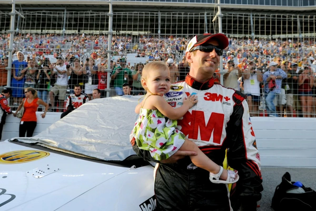 Greg Biffle holds his daughter, Emma, before the NASCAR Sprint Cup Series auto race at Atlanta Motor Speedway, Sunday, Sept. 2, 2012, in Hampton, Ga. (AP Photo/Rainier Ehrhardt)