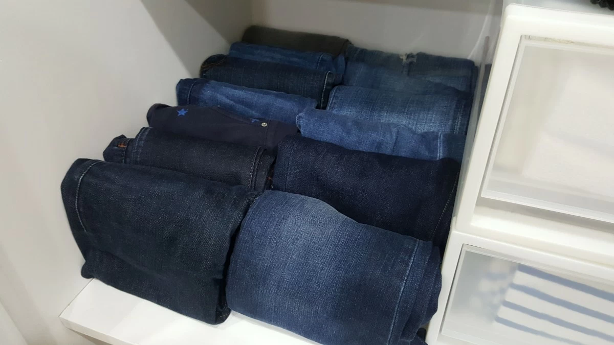 When we fold jeans instead of hanging, they tend to take up less space. In this photo, this small space is able to contain 15 pairs of jeans, when it used to take up half of my hanging closet space.