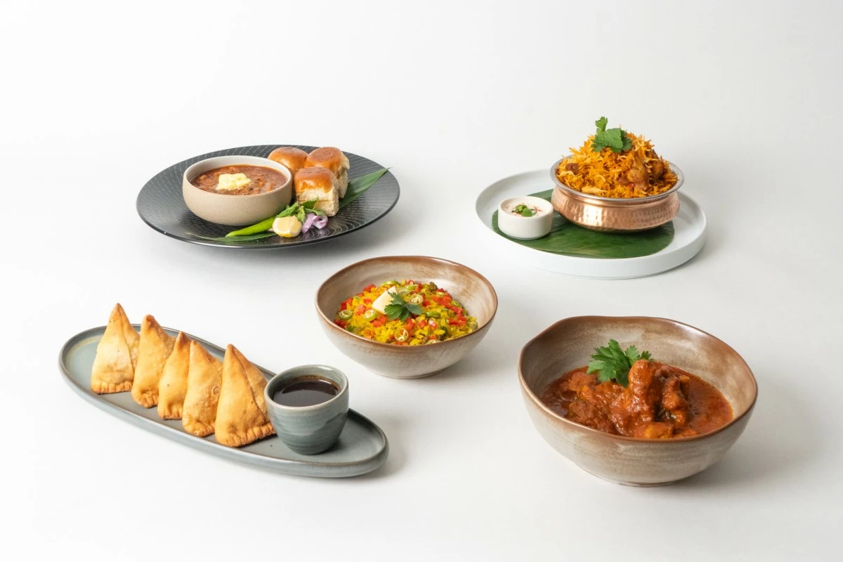 Some of the Indian dishes prepared by Chef Arun Kumar (Pao Bhaji, Chicken Biryani, Poha, Samosa, Chicken Curry)