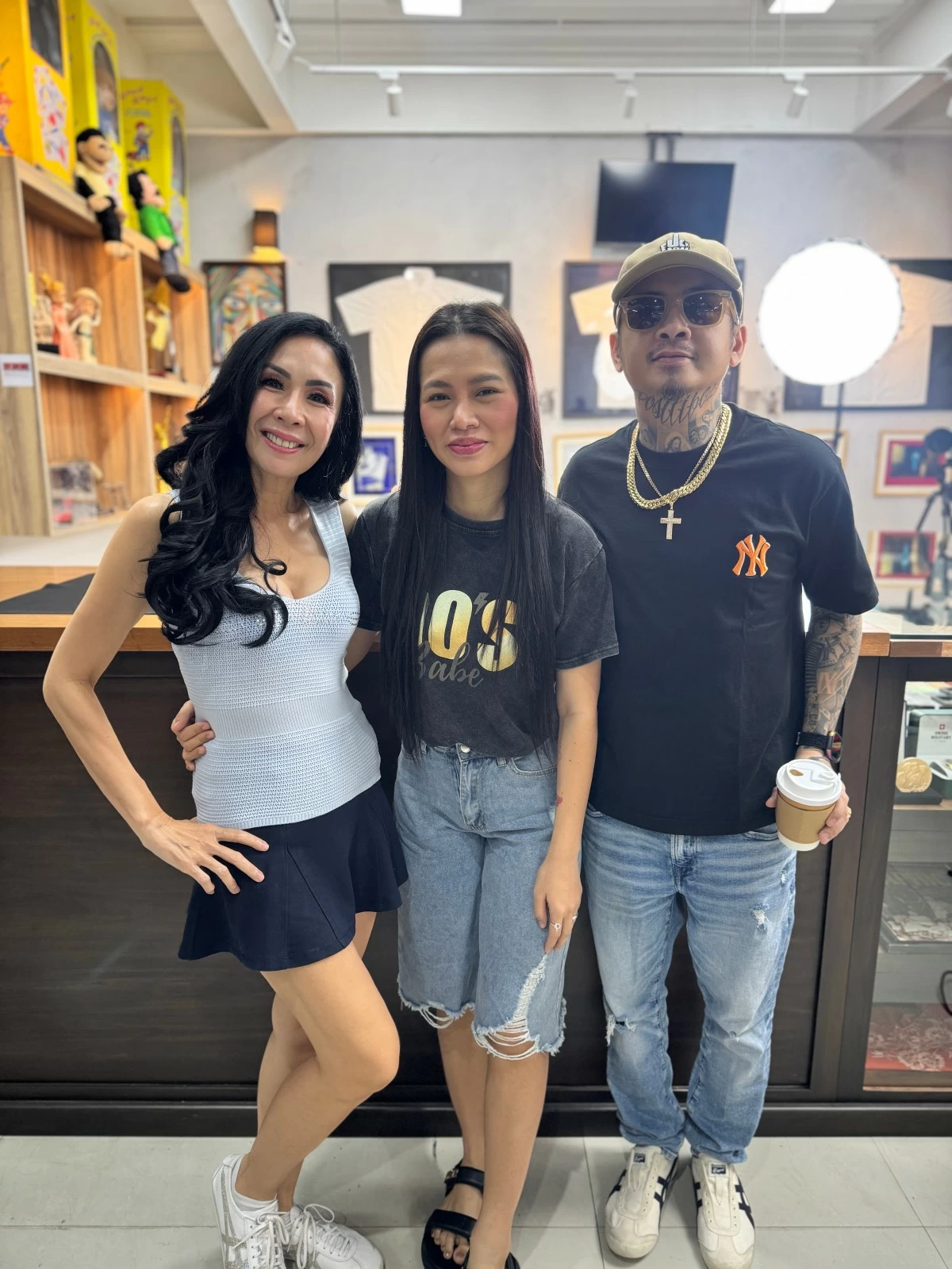 With Boss Toyo and his wife, Joy. Behind is his Holy Grail: the celebrity memorabilia collection, including the three white polos of rap icons Francis M, Chito Miranda, and Glock 9 that they wore during their concert, 'Bagsakan.'