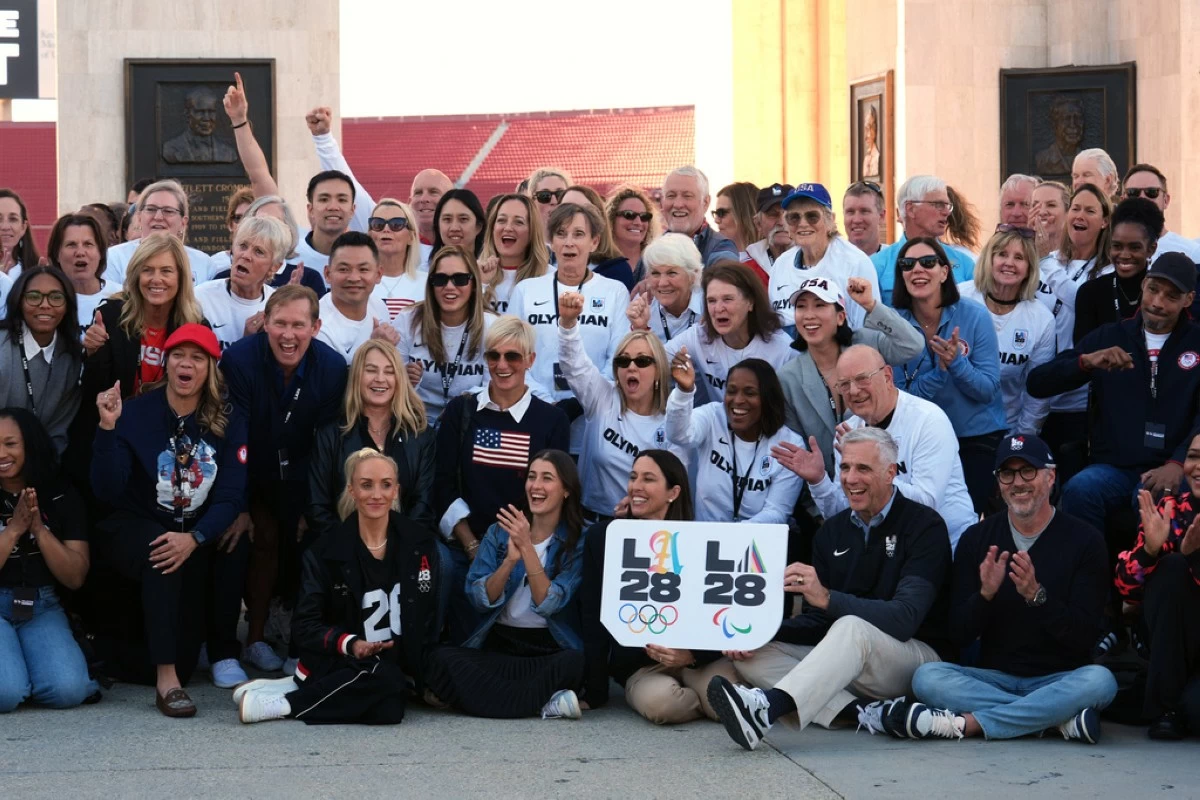 Former Olympians gather for a group photo at the Los Angeles Memorial Coliseum ahead of the launch for ticket registration to the 2028 Summer Olympic Games Tuesday, Jan. 13, 2026, in Los Angeles. (AP Photo/Damian Dovarganes)