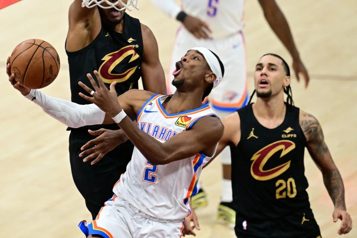 Oklahoma City Thunder guard Shai Gilgeous-Alexander (2) goes to the basket against Cleveland Cavaliers guard Jaylon Tyson (20) during the second half of an NBA basketball game Monday, Jan. 19, 2026, in Cleveland. (AP Photo/David Dermer)