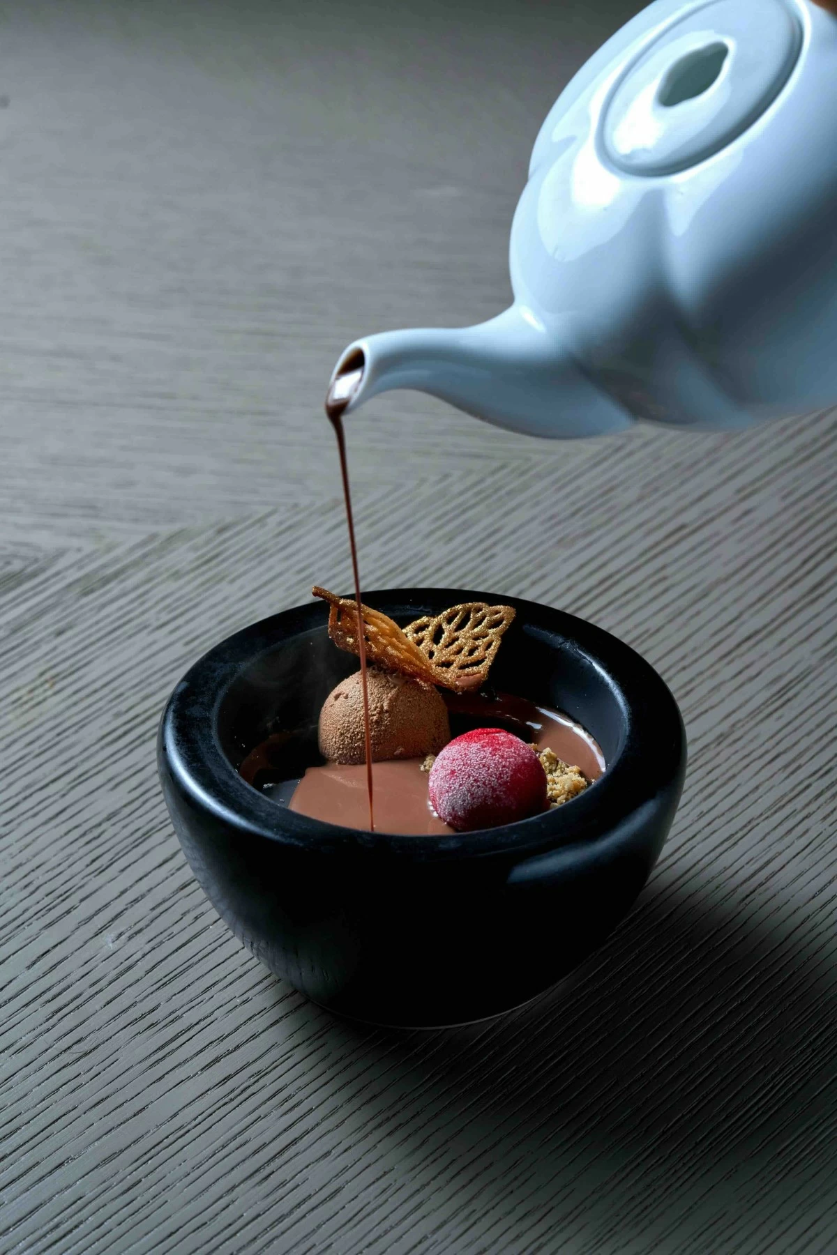 SWEET REVEAL Chocolate and hazelnut sphere opened to reveal espresso, chocolate brownie, cherry sorbet, and bourbon sac.