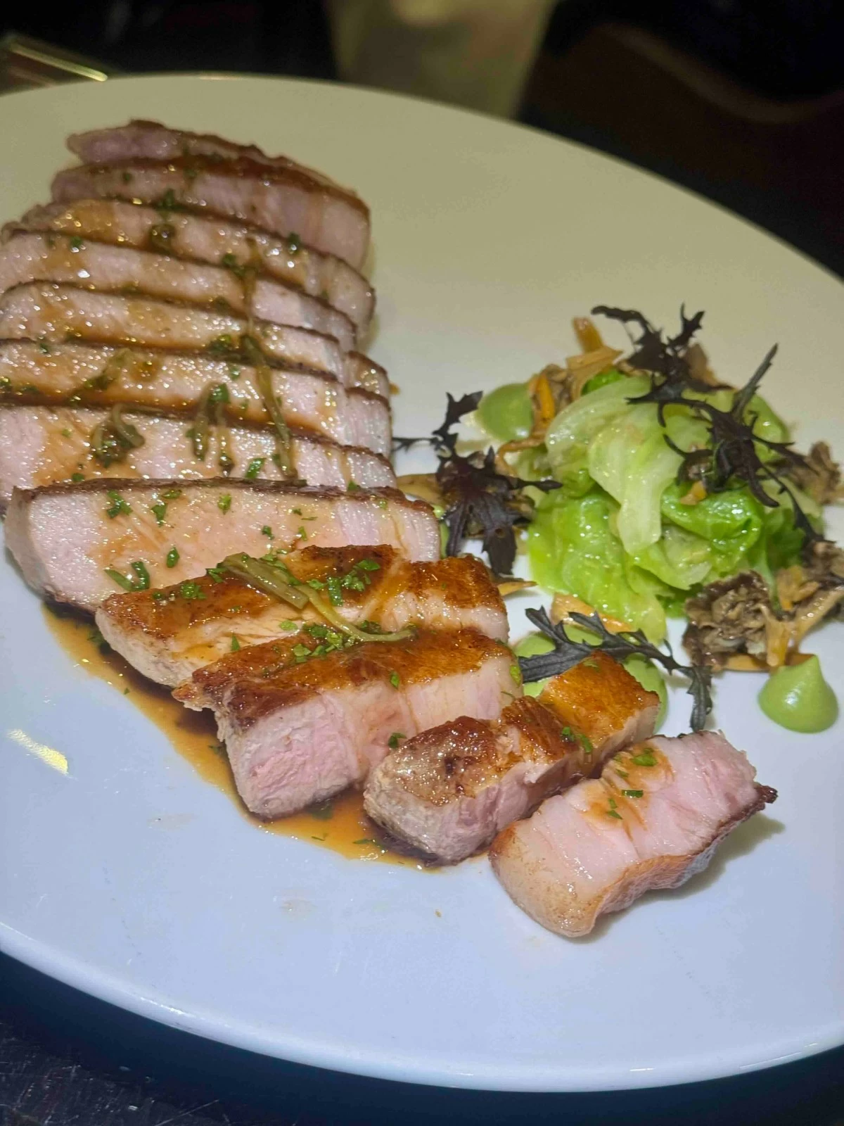 HEARTY CUT  Juicy farmhouse pork chop served with cabbage, ginger, preserved lemon, chanterelles and charcutière sauce.