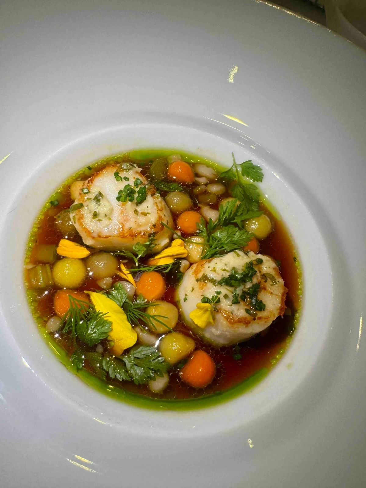 BROTH AND BUTTER  Roasted scallops with horseradish butter in a delicate bone marrow pot-au-feu broth.