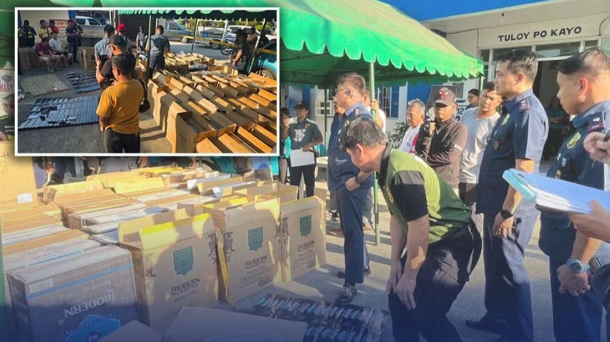 Policemen inspect the boxes containing cigarettes believed to have been smuggled into the country during an operation in Pangasinan on Wednesday, Jan. 21, 2026, Two Chinese were arrested. (photo: PNP) 