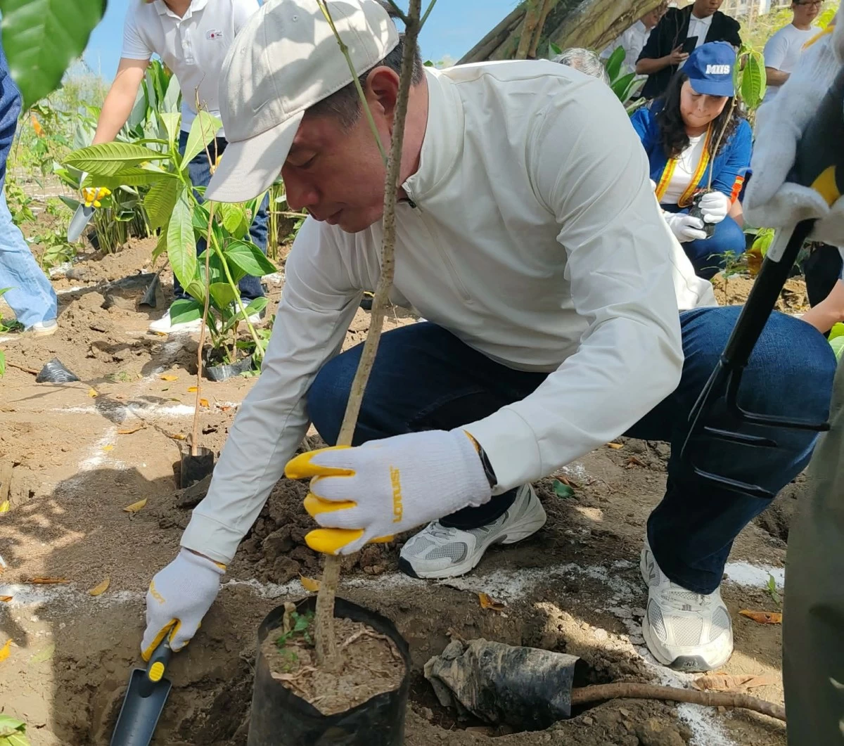 Architect Adrian Chua, COO of Eton Properties, does his share in the tree planting event.
