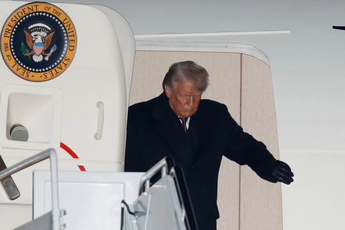 President Donald Trump arrives on Air Force Oneat Joint Base Andrews, Md., Thursday, Jan. 22, 2026, after returning from the World Economic Forum in Davos. (AP Photo/Luis M. Alvarez)