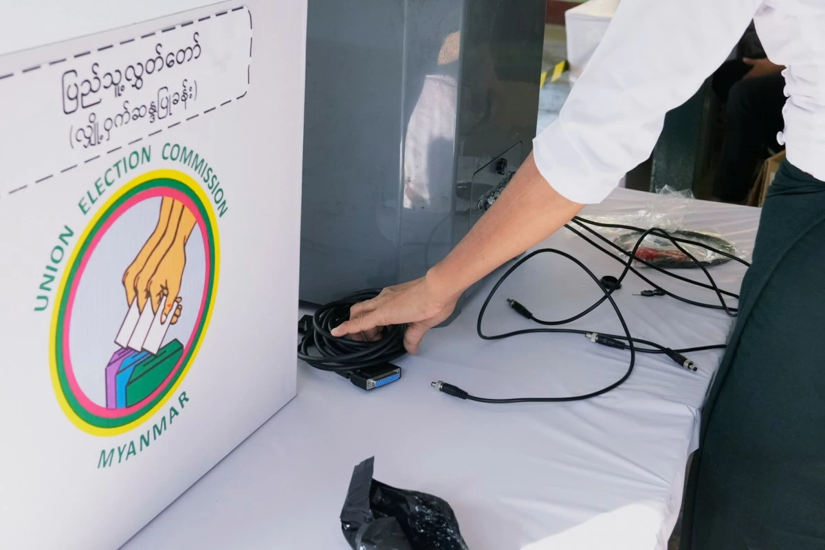 Officials of the Union Election Commission set up an electronic voting machine at a polling station, one day ahead of the third phase of the general election, in Yangon, Myanmar, Saturday, Jan. 24, 2026. (AP Photo/Thein Zaw)