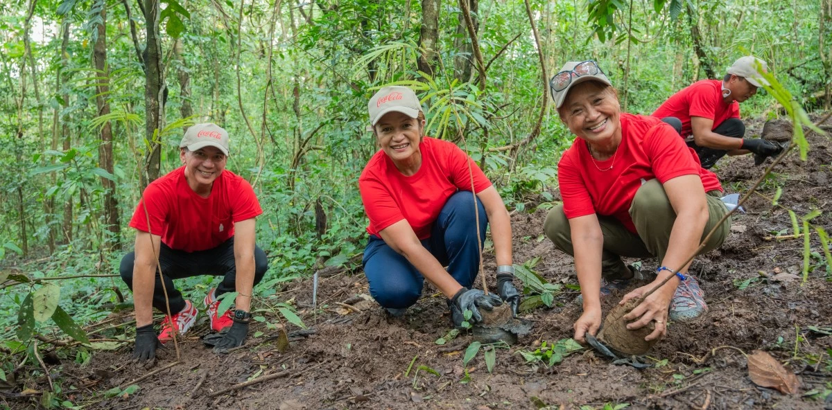 Coca-Cola Philippines employee volunteers plant native seedlings as part of ongoing reforestation efforts.
