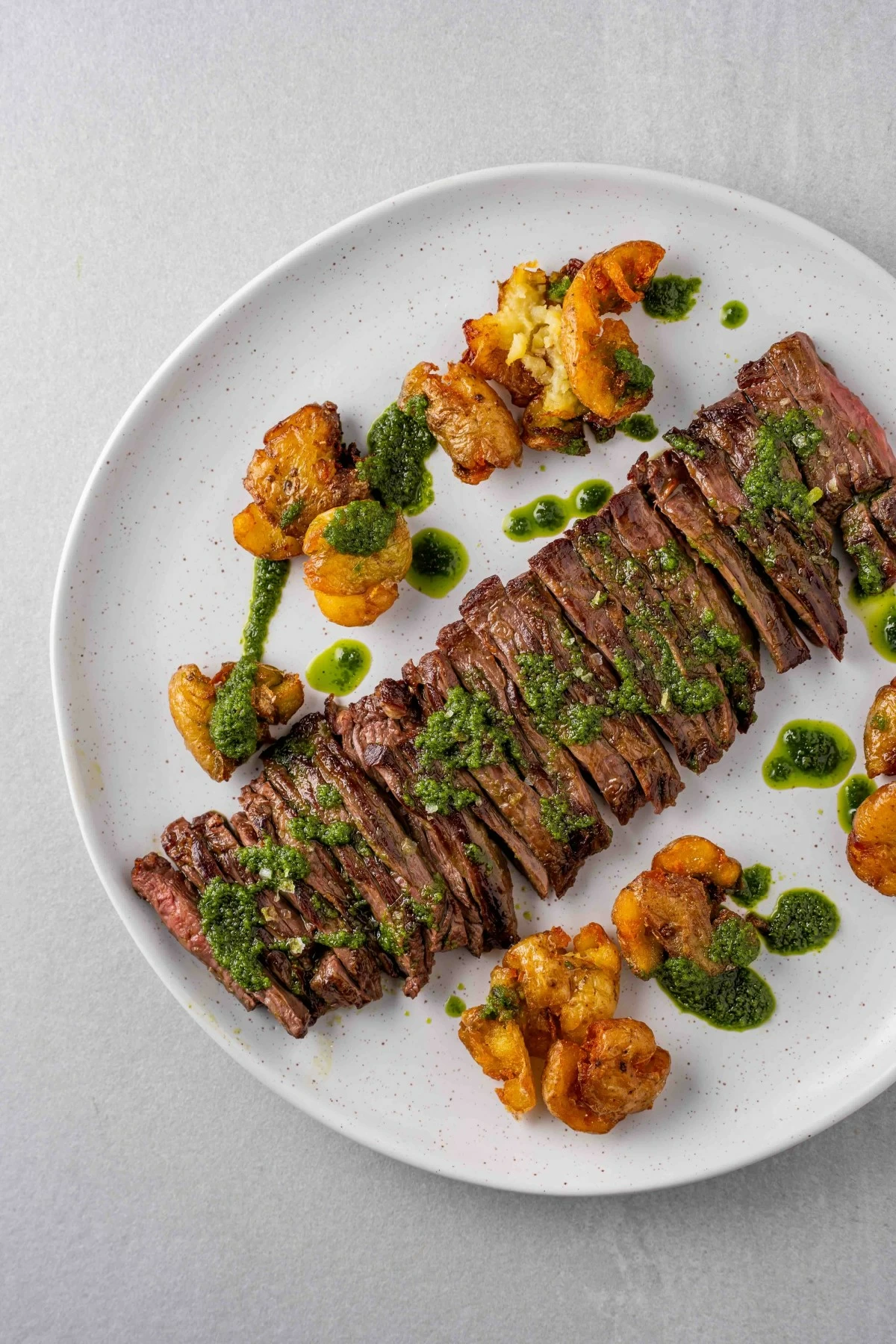 GRILL CLASSIC Churrasco con Chimichurri features skirt steak with herb sauce and marble potatoes