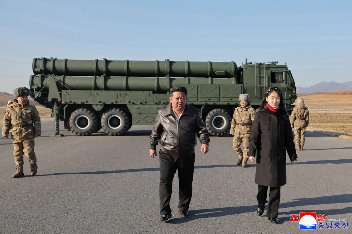 In this photo provided by the North Korean government, its leader Kim Jong Un, with his daughter, believed to be named Kim Ju Ae, inspects test-firing of ballistic missiles from an undisclosed location in North Korea, Tuesday, Jan. 27, 2026. Independent journalists were not given access to cover the event depicted in this image distributed by the North Korean government. The content of this image is as provided and cannot be independently verified. Korean language watermark on image as provided by source reads: 