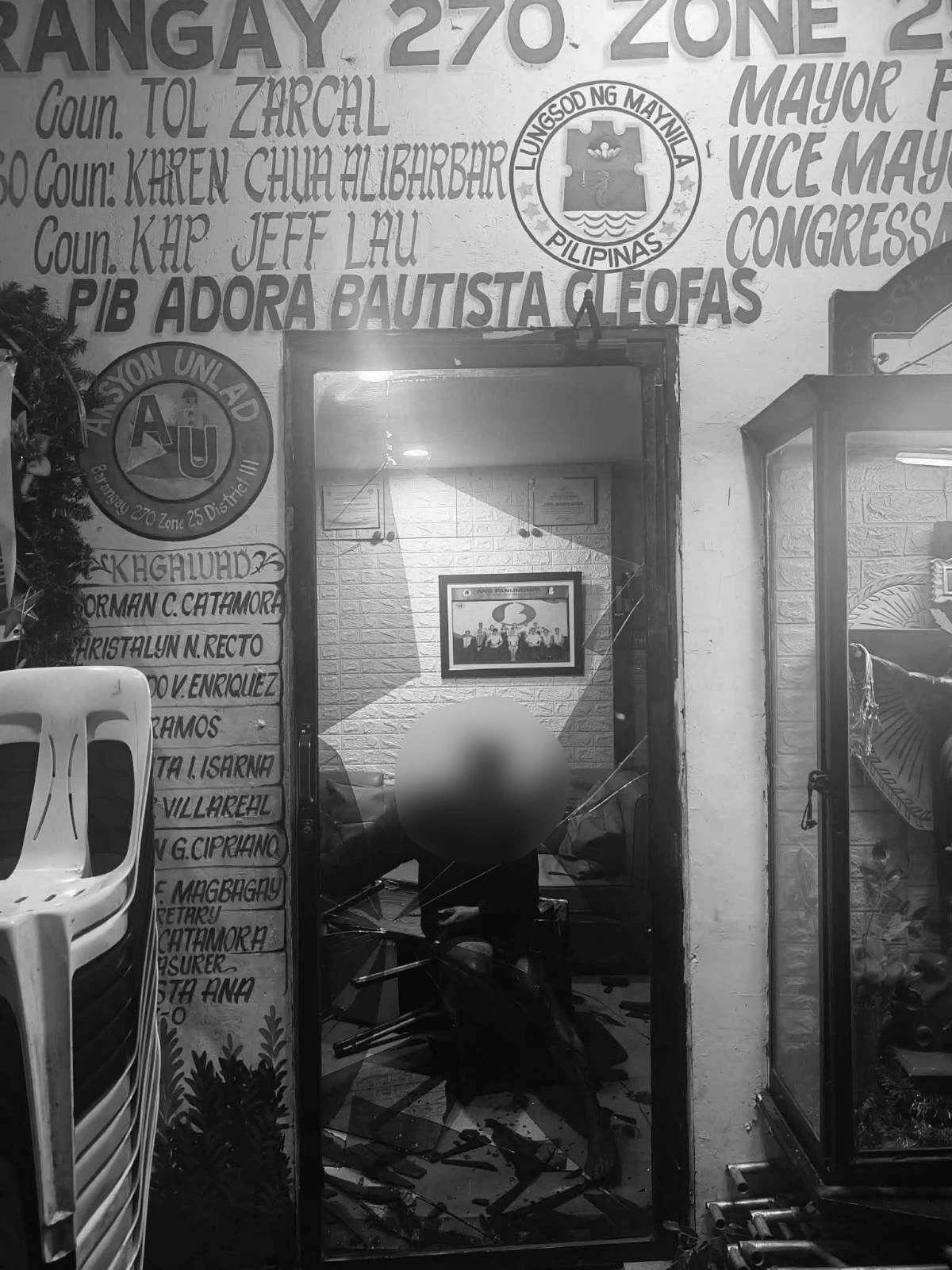 The suspect was seen slumped on the floor while bleeding profusely after forcing his way inside a barangay hall in Binondo, Manila, by bashing its glass door with his head. (Photo from MPD)