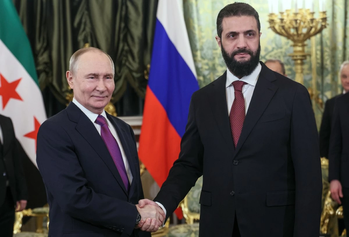 Russian President Vladimir Putin, left, and Syrian interim President Ahmad al-Sharaa pose for a photo during their meeting at the Grand Kremlin Palace in Moscow, on Wednesday, Jan. 28, 2026. (Maxim Shipenkov/Pool Photo via AP)