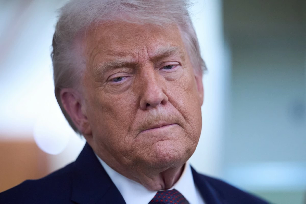President Donald Trump speaks with reporters aboard Air Force One after leaving the World Economic Forum in Davos for Washington, Thursday, Jan. 22, 2026. (AP Photo/Evan Vucci)