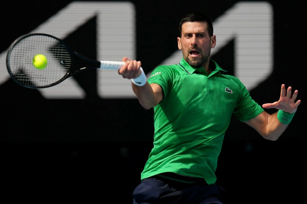 Novak Djokovic of Serbia plays a forehand return to Lorenzo Musetti of Italy during their quarterfinal match at the Australian Open tennis championship in Melbourne, Australia, Wednesday, Jan. 28, 2026. (AP Photo/Dar Yasin)