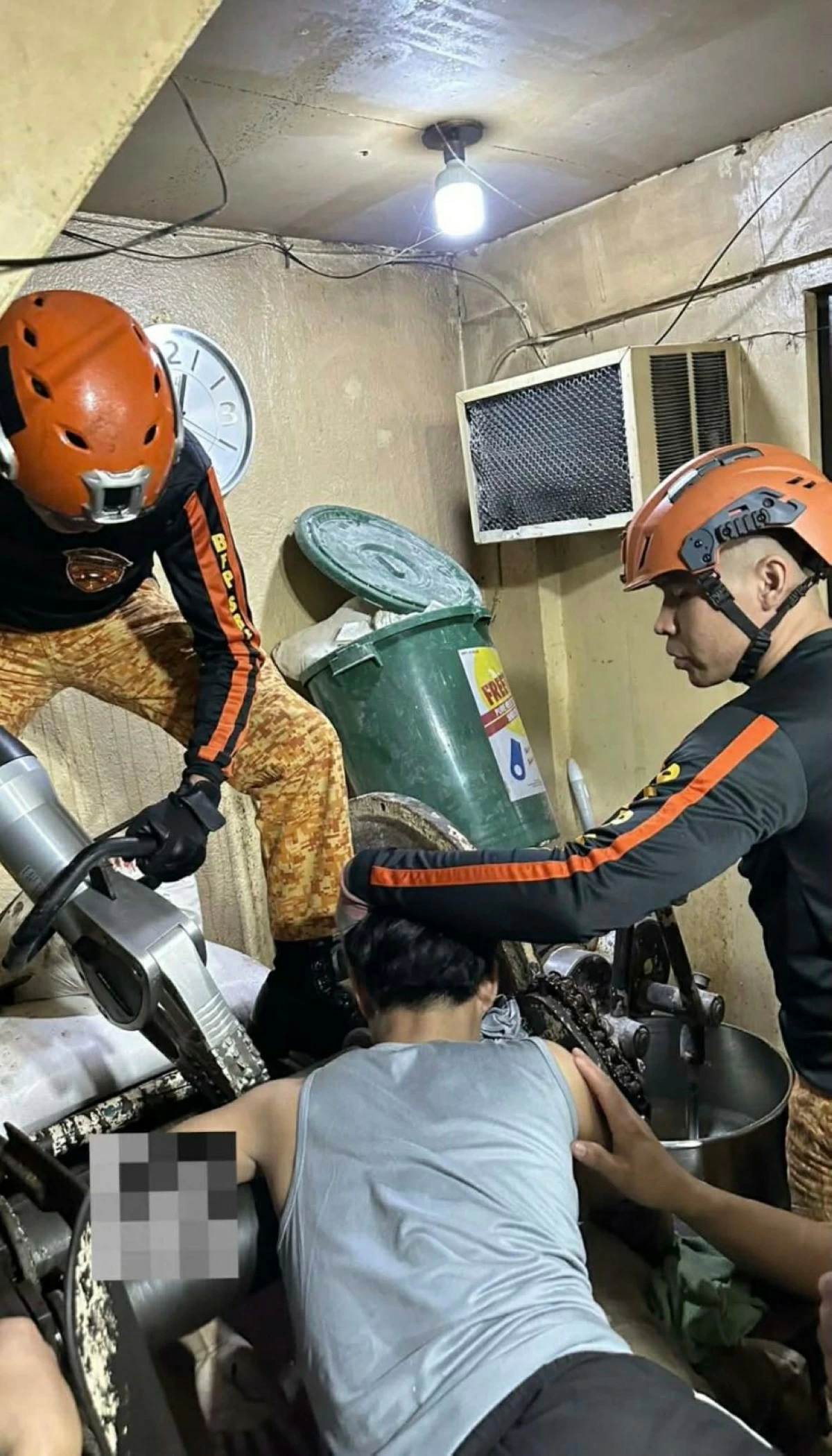 Members of the Pasay City Bureau of Fire Protection (BFP) help extract the hand of a baker that was caught and mangled by a dough roller machine. (Photo from Pasay BFP)