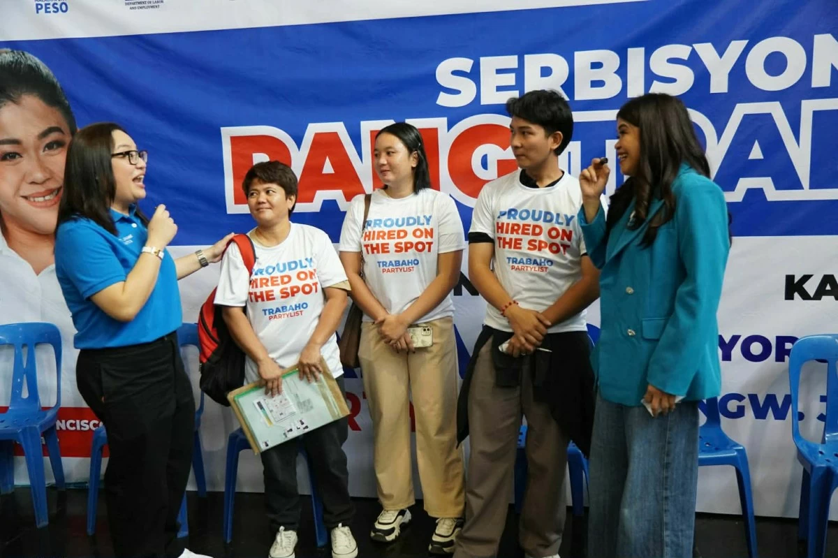 TRABAHO Party-list Rep. Johanne Bautista (leftmost) and Melai Cantiveros-Francisco (rightmost) engage applicants hired on-the-spot in a conversation (Trabaho Party-list)