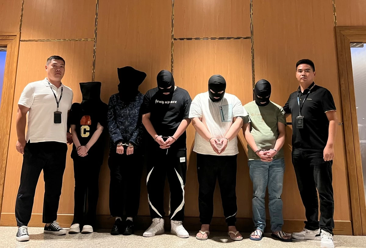 FILE - In this photo released by Xinhua News Agency, Myanmar police hand over five telecom and internet fraud suspects to Chinese police at Yangon International Airport in Yangon, Myanmar, Aug. 26, 2023. (Chinese embassy in Myanmar/Xinhua via AP)