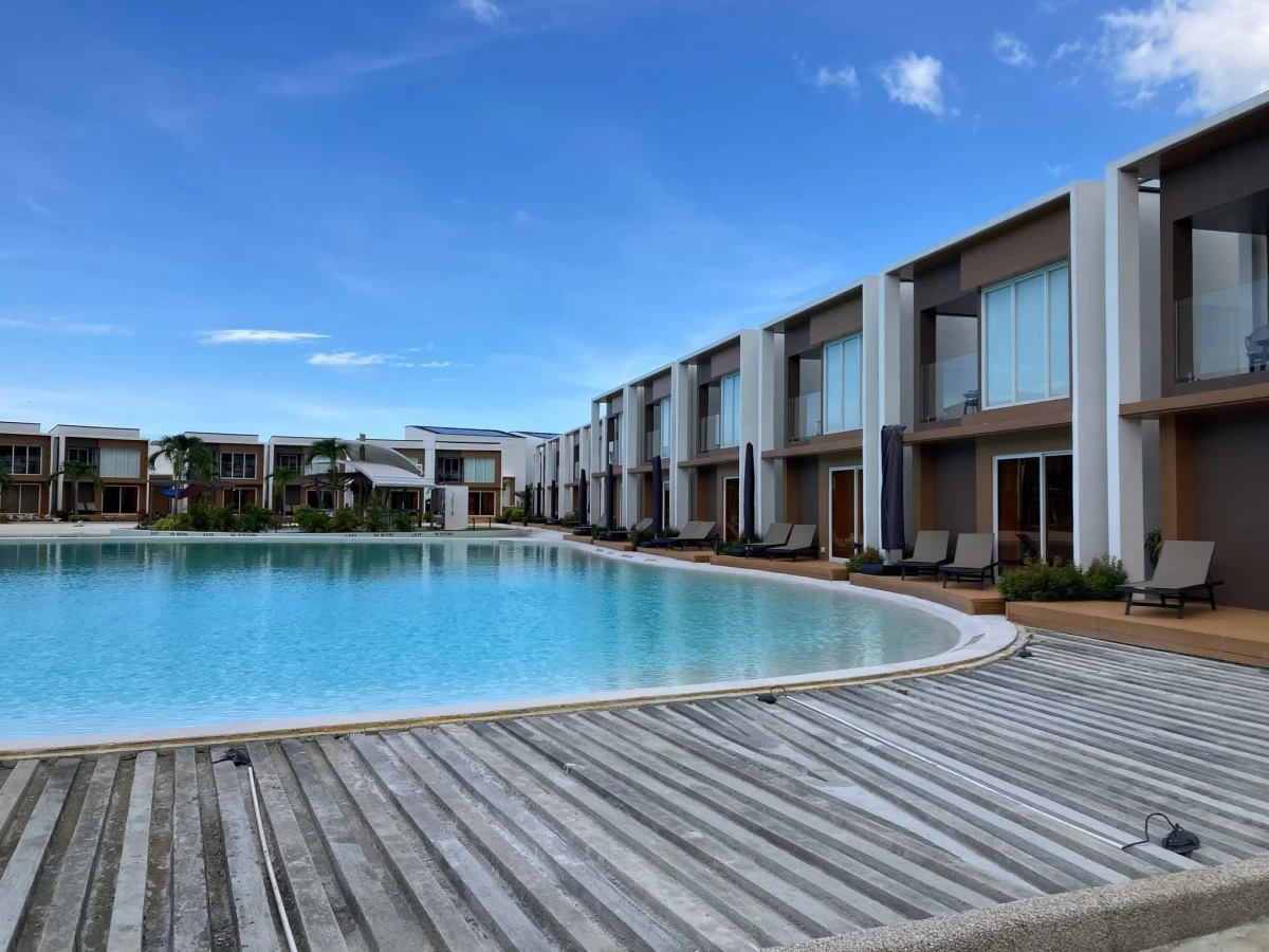 TAKE THINGS EASY Lounge by the lagoon-style pool and forget tomorrow's troubles.