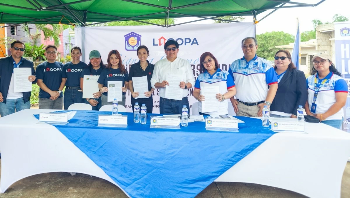 Pag-IBIG Fund and Lhoopa representatives mark the signing of a Memorandum of Understanding at Townhill Tanay, formalizing their collaboration to support the financing and delivery of green affordable housing for Pag-IBIG members.
