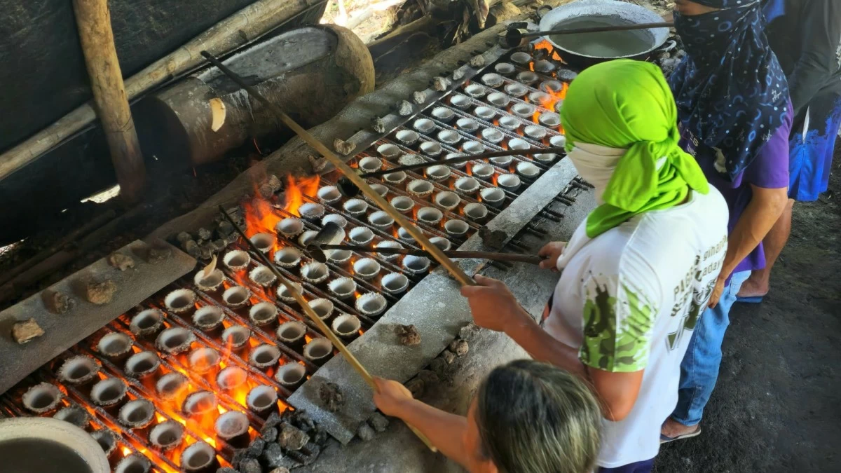 CRAFT IN FLAME Artisans prepare the coconut-husk ash and brine used in the time-honored process of making asin tibuok, a salt tradition inscribed in UNESCO’s heritage list