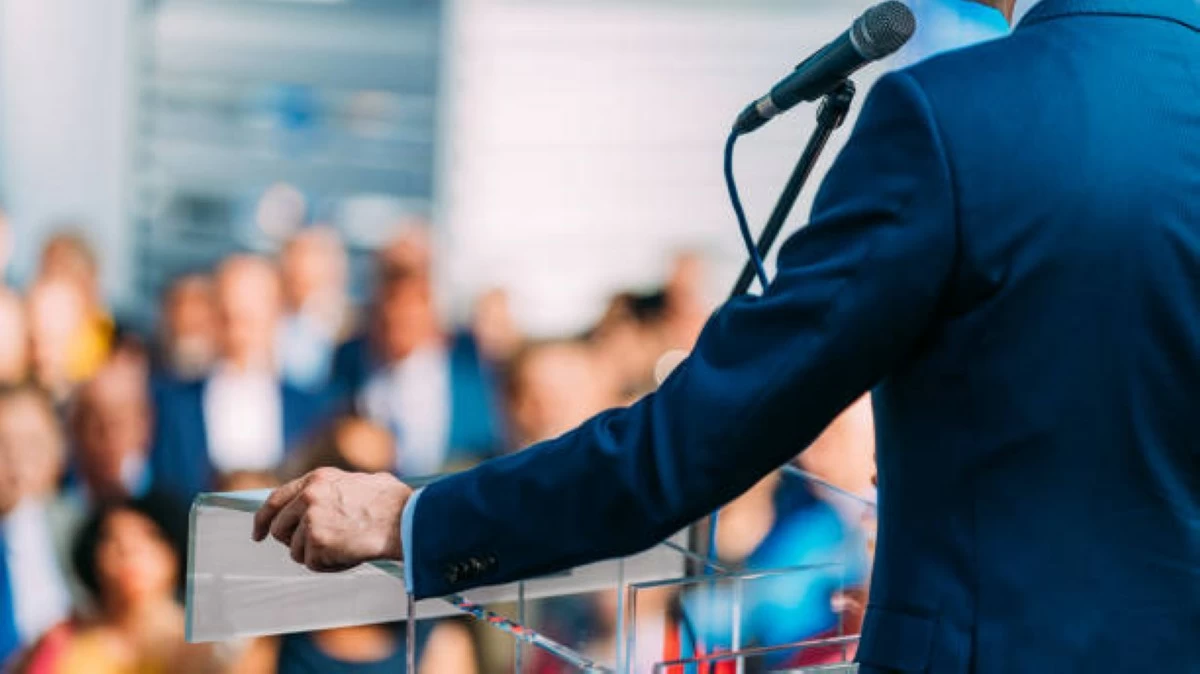 Politician speaking to the crowd from stage (Stock photo)